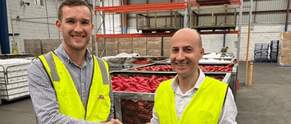 two men shaking hands in utility vest
